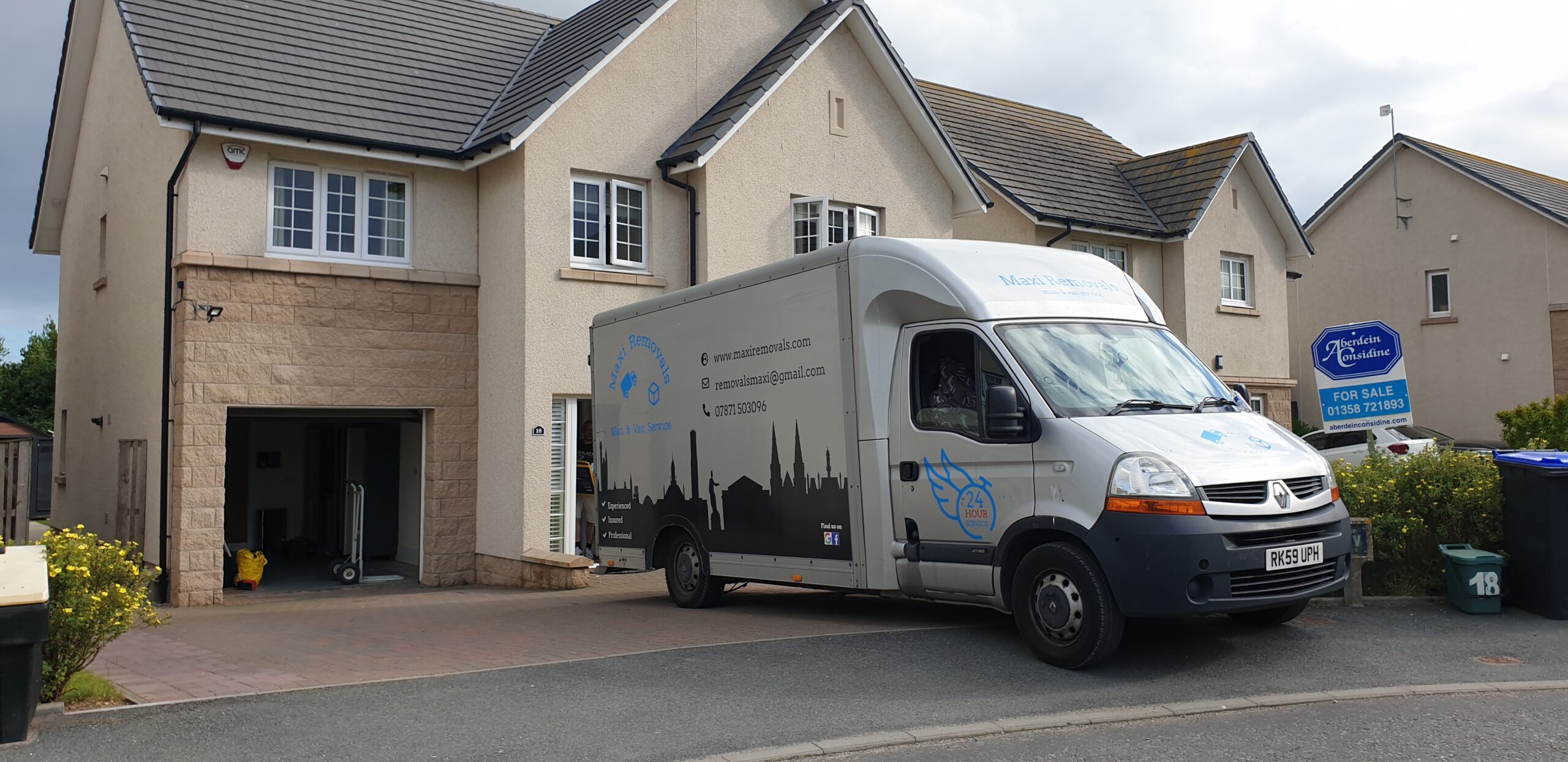 maxi van next to a residential house