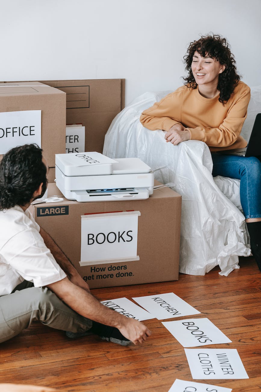 man printing signs for boxes