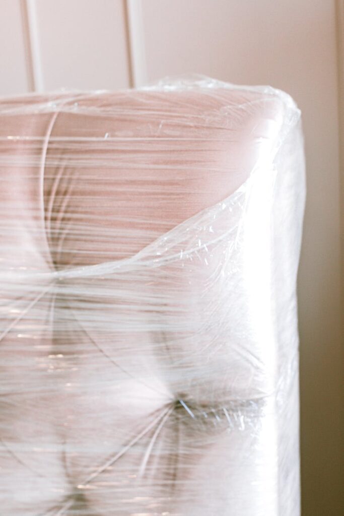 close up photo of couch wrapped with plastic