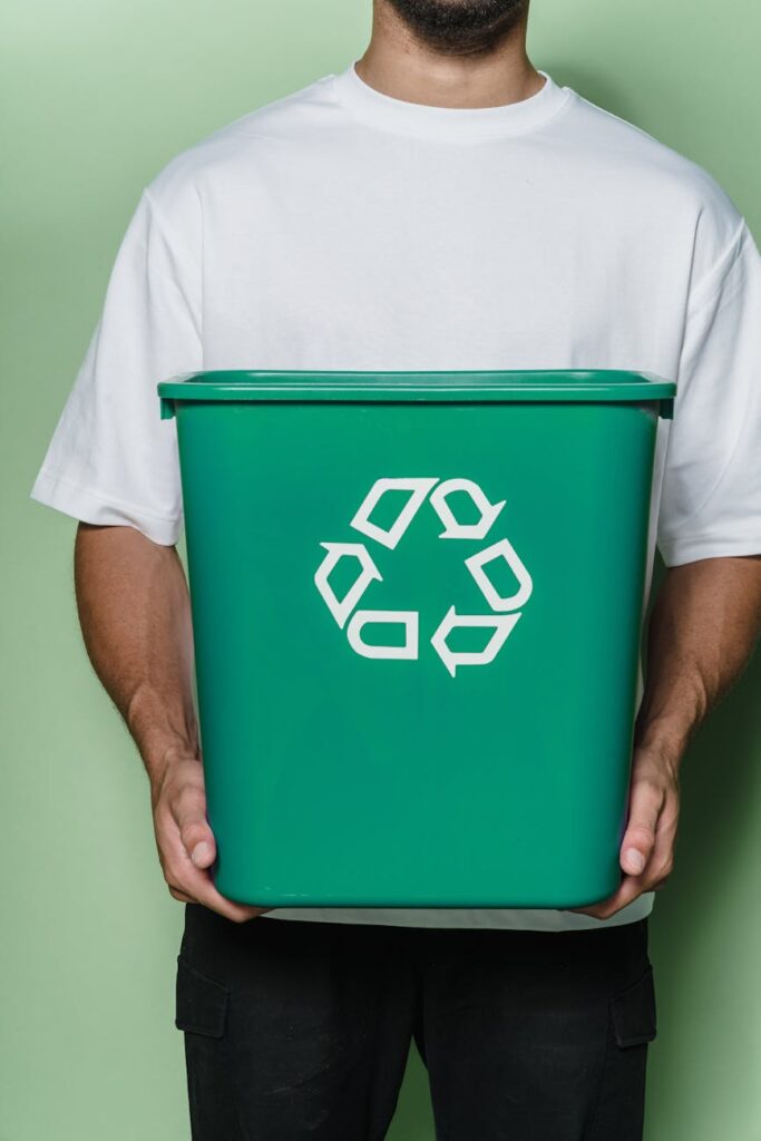 man in white t shirt holding green box